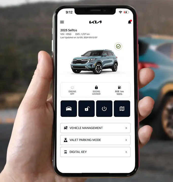 person holding phone with kia connect on it