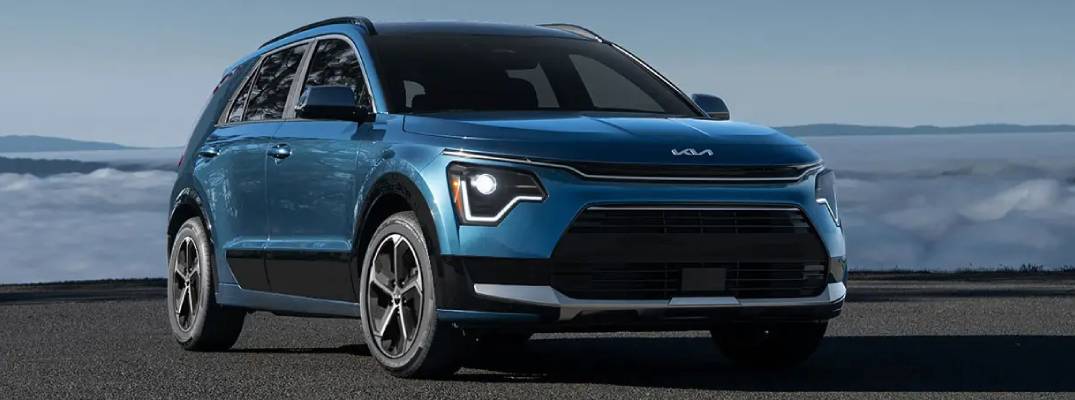 Niro PHEV parked on a gravel road during the day. 