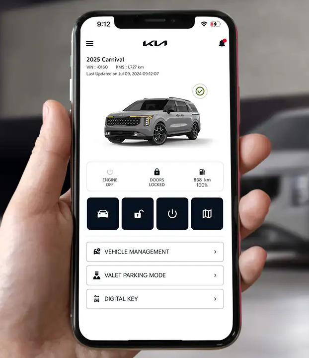 Person holding phone showing kia connect app.