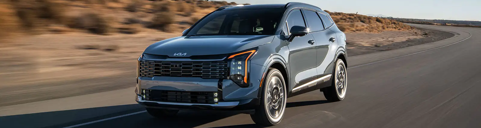 2026 Kia Sportage HEV driving on road.