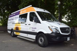 Victoria Cool Aid Society and TELUS Health Mobile Health Clinic van parked outdoors, used for community outreach and healthcare services in Victoria, BC.