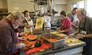 Volunteers preparing meals in the kitchen at Rainbow Kitchen in Victoria, BC, a community organization that provides free meals and support to people in need.