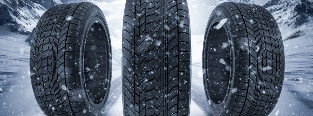 Image of three tires standing together with snow in background