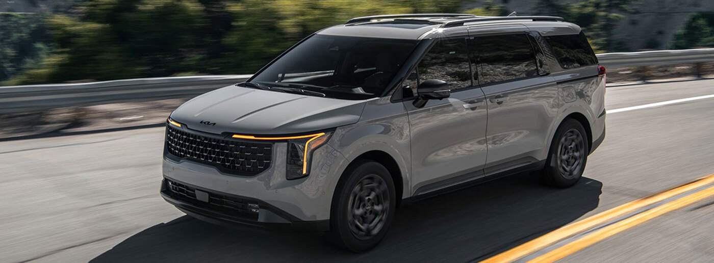 2026 Kia Carnival HEV driving down road