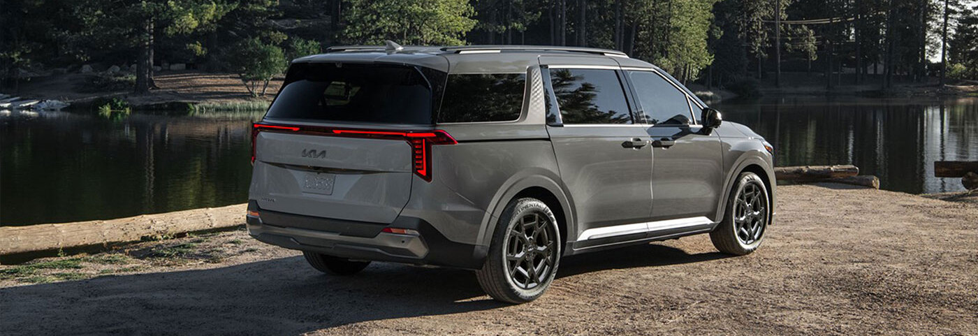 2026 Kia Carnival HEV parked near body of water