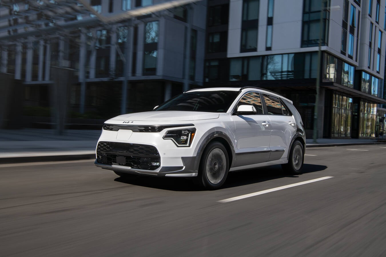 Kia Niro EV driving on city road.