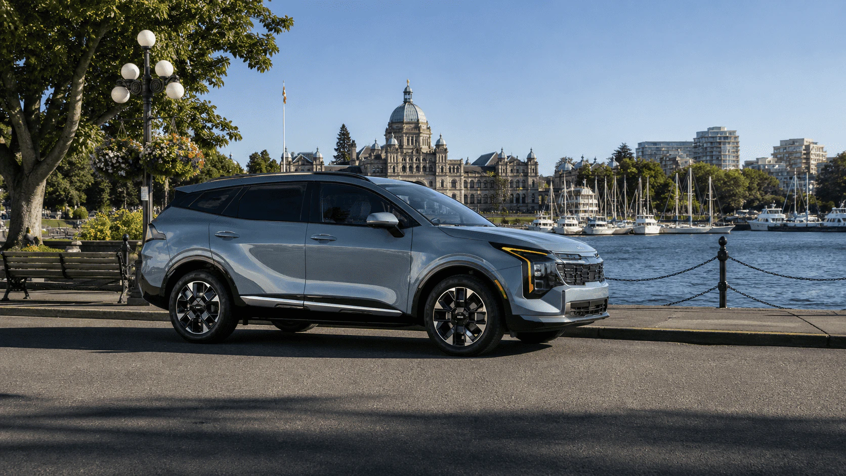 2026 Kia Sportage parked by Victoria Inner Harbour with BC Legislature in background