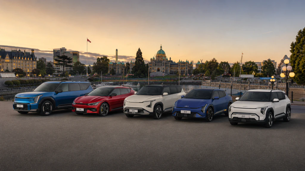 The Kia EV line-up in Victoria's inner harbour at sunset. 